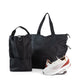 Large black bag with Large black tote beside a pair of white sneakers