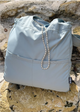 Misty Blue bag resting in nature on rocks