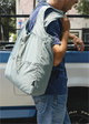 Misty Blue bag over man's shoulder