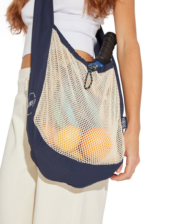 girl wearing net bag across their body and hanging at their waist