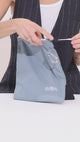 girl shows items in the wet and dry pouch
