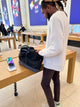 Person in an electronics store with the black bag on a table