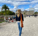 woman wears net bag with rust straps while outside