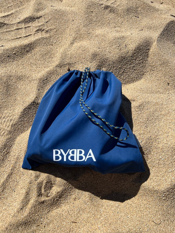 blue pouch in beach sand
