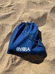 blue pouch in beach sand