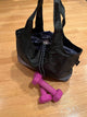 black bag on the floor next to pink weights