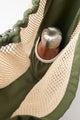 inside view of net bag with water bottle pocket holding a water bottle