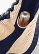 Inside view of net bag featuring water bottle pocket holding a water bottle