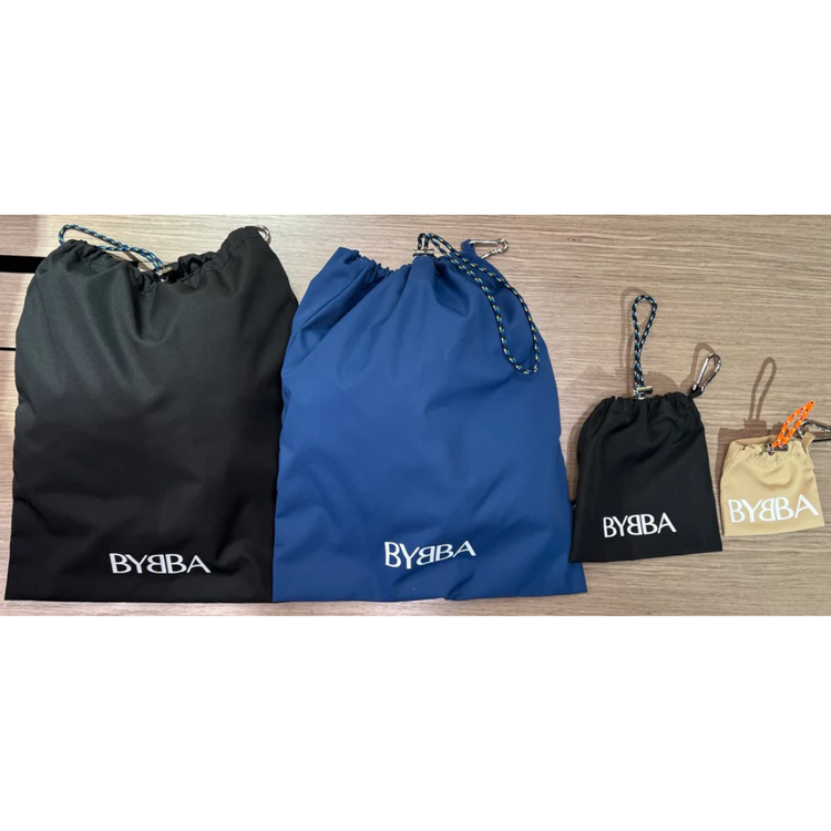 Packable, foldable, reusable drawstring bags in black, blue, and beige, made from recycled ocean plastic by BYBBA.