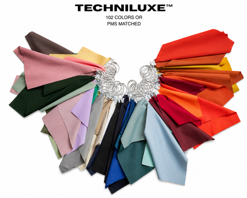 BYBBA Techniluxe™ fabric color swatch collection featuring 102 colors or PMS-matched fabric options, arranged in a fan display with neutral, pastel, blue, green, red, orange, yellow, pink, and burgundy textile samples.