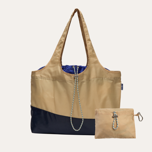 Beige and navy tote bag with matching pouch on a white background by BYBBA made from plastic from the ocean