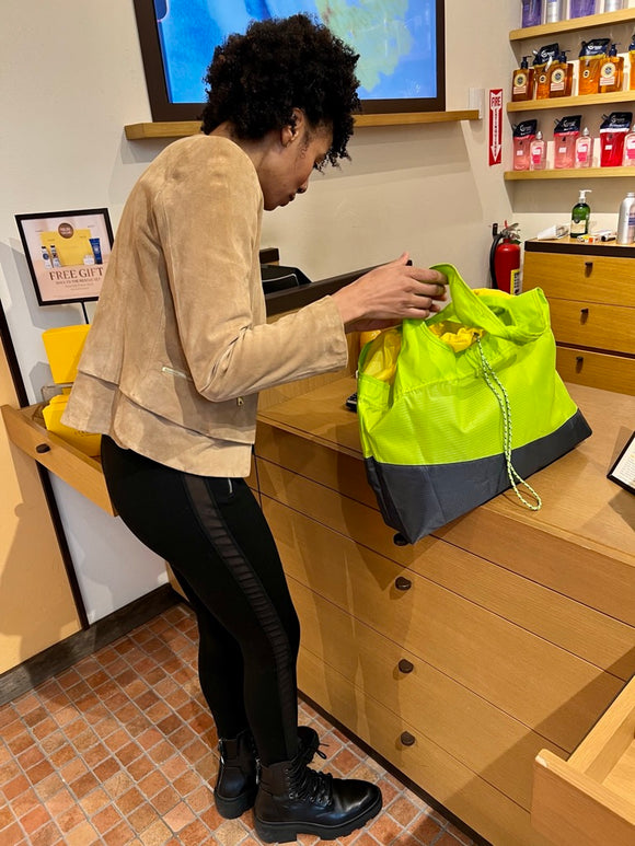 girl with green bag on the counter top