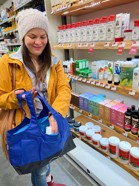 girl using blue bag in the cosmetic section in a store