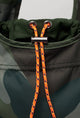 orange drawstring closure on green camo tote bag