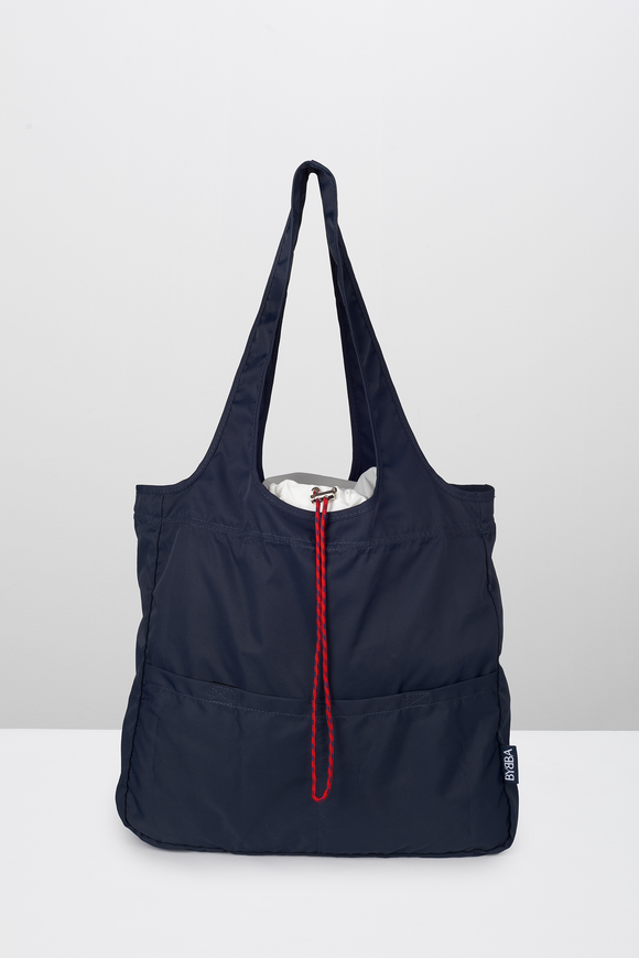 Navy blue tote bag with red drawstring closure