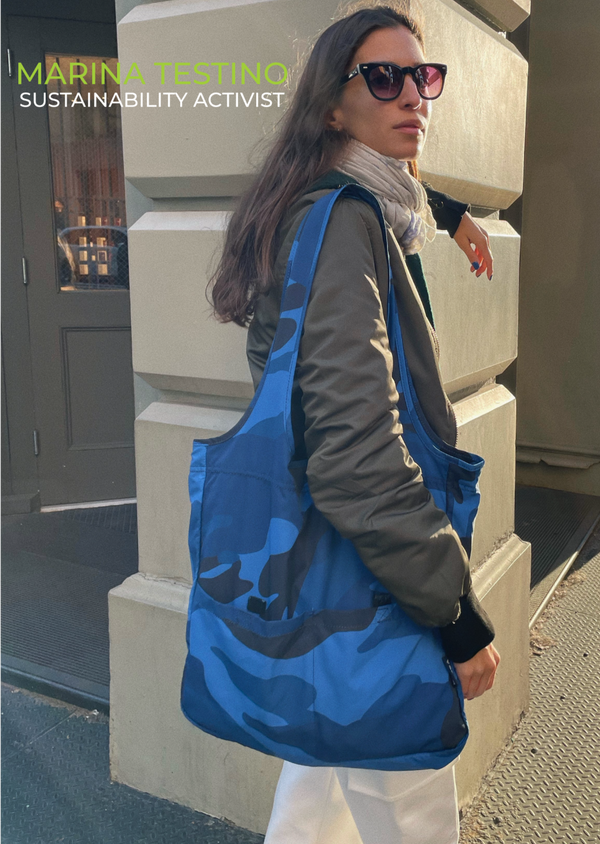 Marina Testino carrying her blue camouflage recycled tote bag
